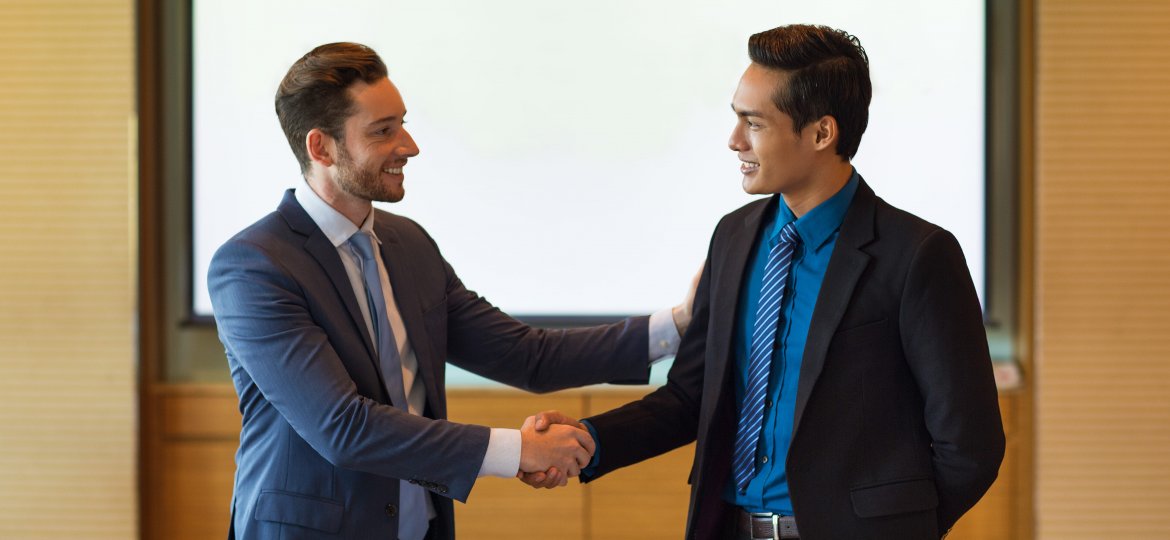 Smiling Business Leader Greeting Partner
