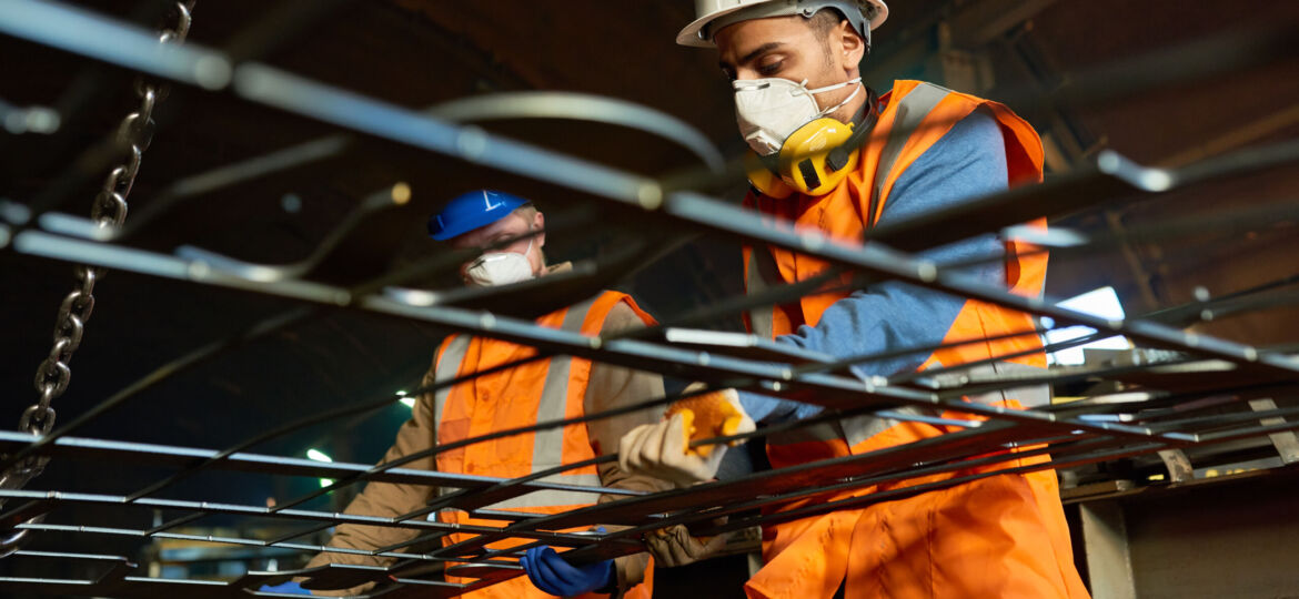 Young Workers Using Lifting Beam