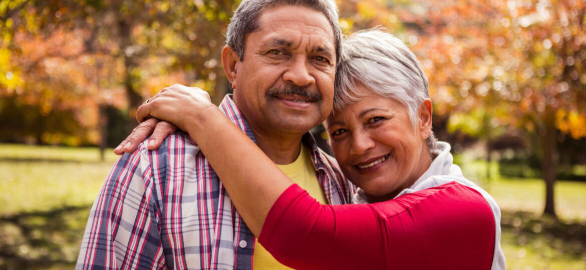 Elderly woman hugging his husband in the park
